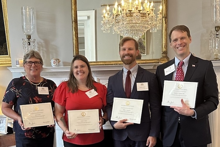 인증서를 들고 서로 옆에 서있는 사람들의 그룹